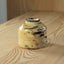 Decorative stone object on a wooden surface